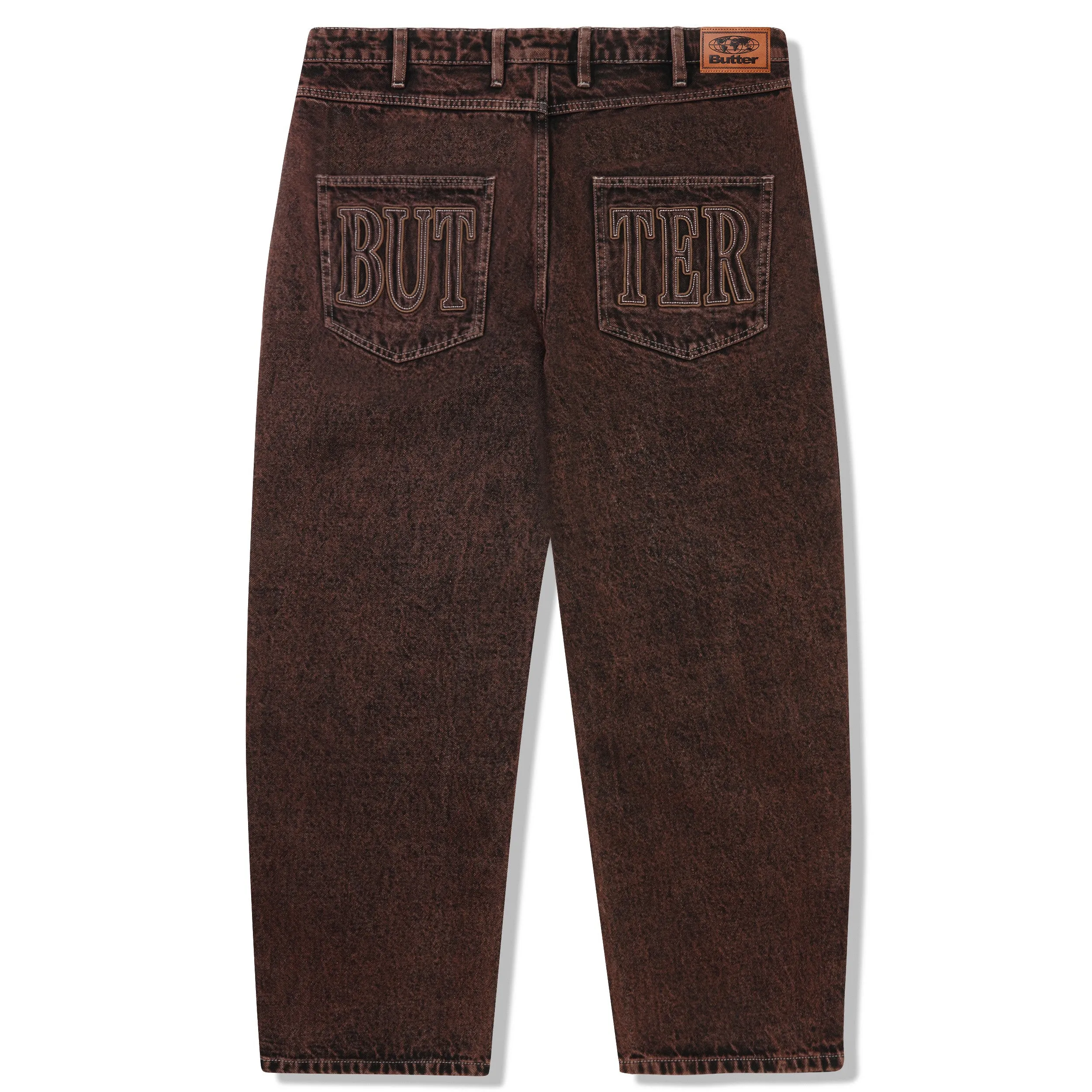 Brown acid wash denim jeans with Butter Goods applique